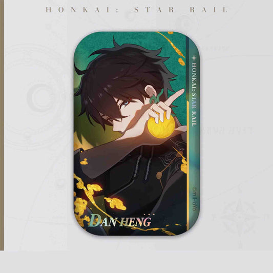 A close-up of Dan Heng from Honkai: Star Rail, holding a glowing golden orb. Dark green and black tones with golden accents highlight his calm, focused expression.