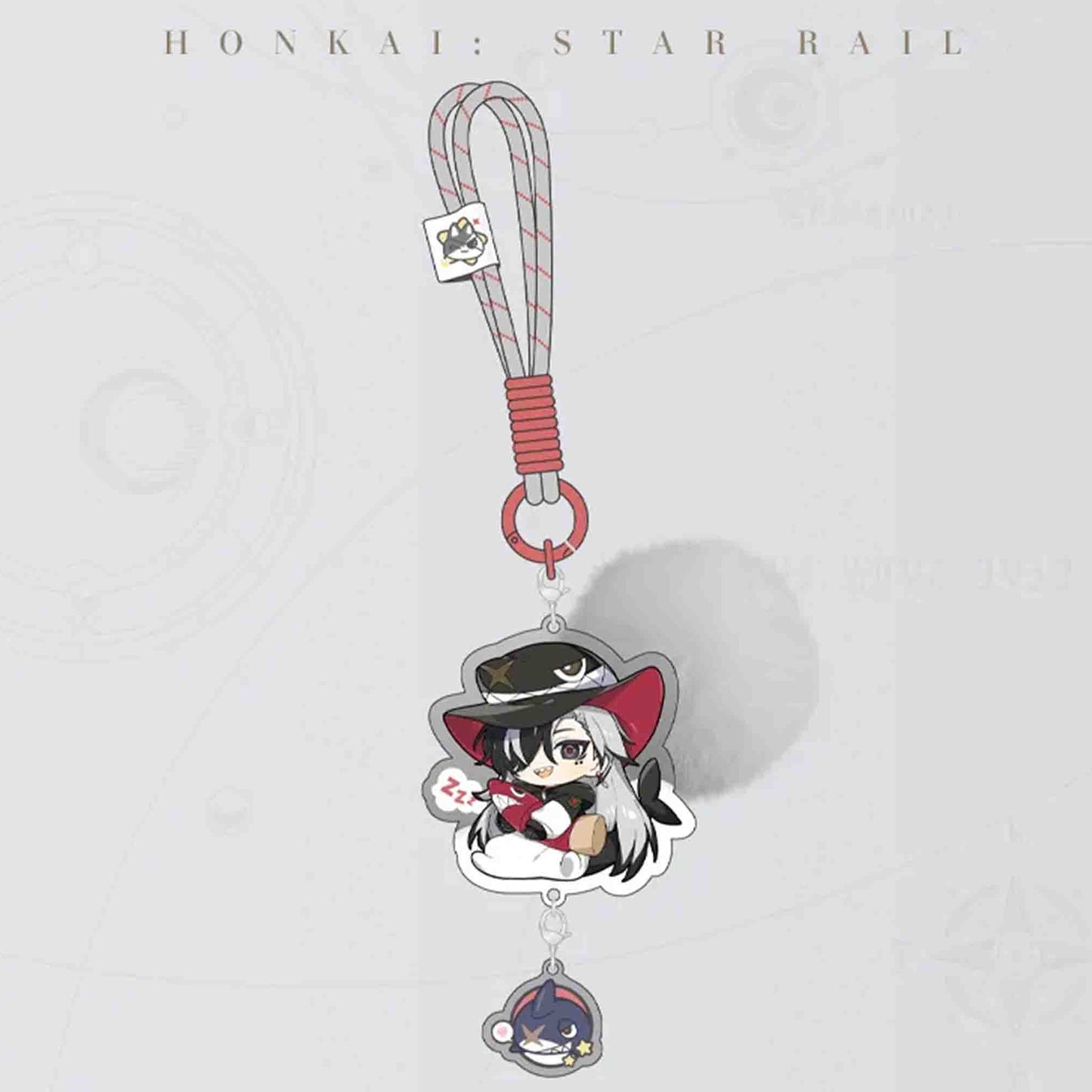 A single Honkai: Star Rail acrylic keychain with a grey lanyard. The charm features a character in a black hat and red scarf, plus a small dark-haired pendant.