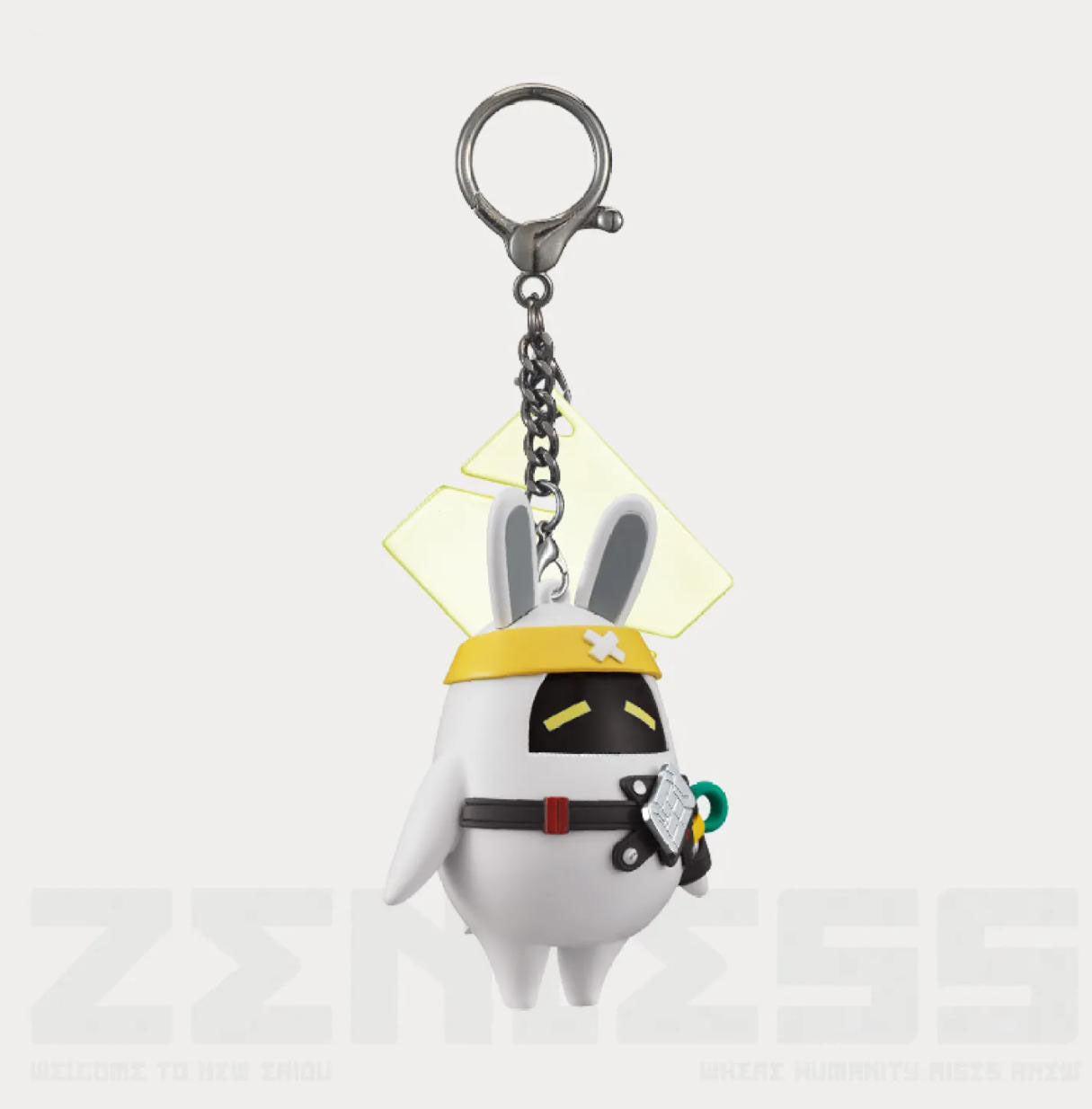 This is a keychain version of the white rabbit-eared figurine, attached to a metal key ring via a chain. A yellow diamond-shaped transparent accessory is fixed to its back. The keychain is presented against a plain white background, clearly showing its function as a portable charm.