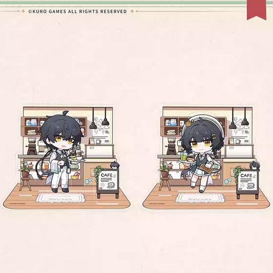 Two chibi-style magnetic acrylic stands of the Male and Female Wanderers from Wuthering Waves, featuring a cozy cafe backdrop with detailed kitchen elements and "CAFE" signage.