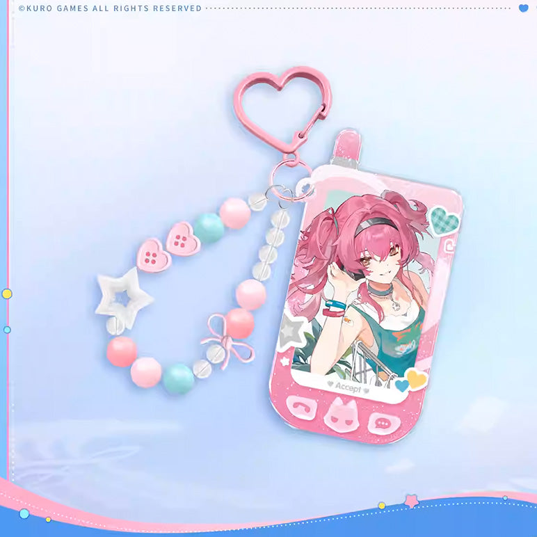 A phone-shaped acrylic charm of Phrolova, paired with a pink beaded strap decorated with stars and bows, and a heart-shaped clasp. The charm has a “Accept!” design.
