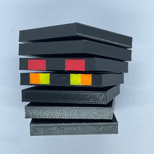 Angled view of Minecraft Magma Cube figurine, layered black plastic blocks with glowing pixel eye details