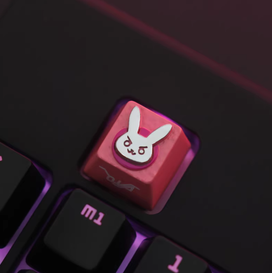 Overwatch D.VA bunny metal keycap, pink base, silver emblem, installed on mechanical keyboard, dark red backlight, close-up.