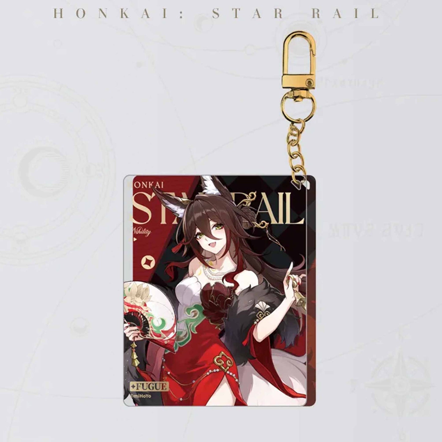 The Fugue keychain features her festive red attire, a holographic finish, and a matching gold metal clasp and chain.