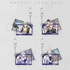 Four Honkai: Star Rail postcard-style acrylic keychains are displayed, featuring the Female Trailblazer, Male Trailblazer, Robin, and Sunday. Each has a die-cut, stamp-like border and a secure metal clasp.