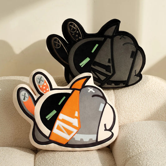 Two irregular-shaped Bangboo plush pillows from the Ennimbun Series of Zenless Zone Zero, featuring a classic orange-gray Bangboo and a sleek black Bangboo, displayed on a soft beige couch against a warm light background. 
