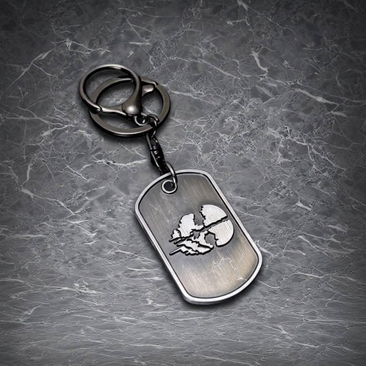 This is a sleek, metallic dog tag keychain featuring an intricate emblem, perfect for adding a touch of style to your keys or accessories.