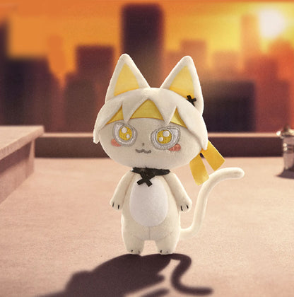 This is a white cat doll. It has pinkish-yellow inner ears and yellow accents on its head, with large, round eyes that have yellow and white embroidered details and pink blush marks on its cheeks. 