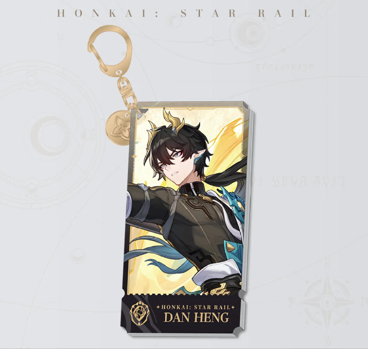 This Honkai: Star Rail acrylic keychain features Dan Heng in a dynamic combat pose with golden horns, with a golden clasp and chain, set against a warm yellow backdrop.