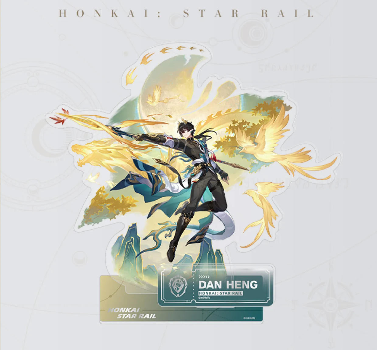 This Honkai: Star Rail acrylic stand features Dan Heng in a swift, spear-wielding pose, surrounded by golden phoenix energy and mountain peaks, with a themed display base.