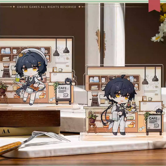 Two chibi-style magnetic acrylic stands of the Male and Female Wanderers from Wuthering Waves, featuring a cozy cafe backdrop with detailed kitchen elements and "CAFE" signage.