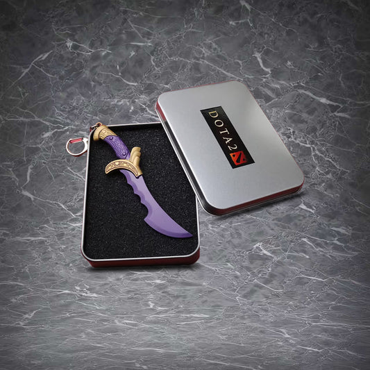 Mini Kunkka's Ghostblade keychain, purple blade with gold accents, attached to a silver keyring, packed in a Dota 2 tin box.