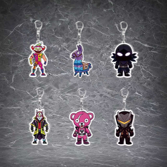 Six Fortnite-themed chibi acrylic keychains hang in two rows against a gray marble background, featuring vibrant character designs including a clown, loot llama, shadowy figure, fox-masked character, pink bear, and armored hero, each with a silver keyring attachment.