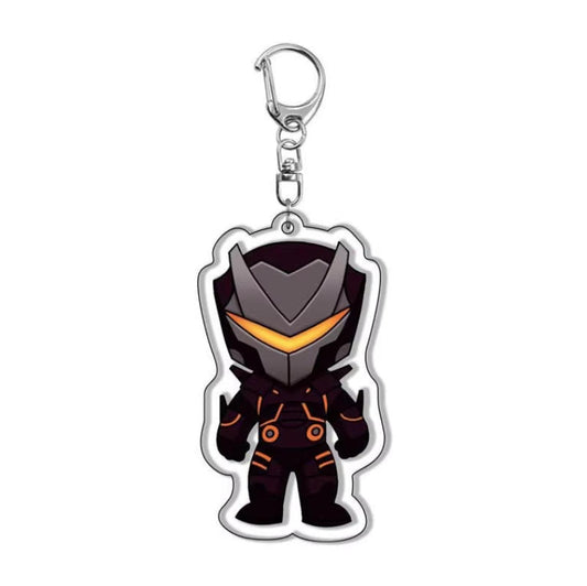 A chibi-style Fortnite armored hero acrylic keychain with a sleek black and gray helmet, glowing yellow visor, and futuristic armor details, attached to a silver keyring against a gray marble background.