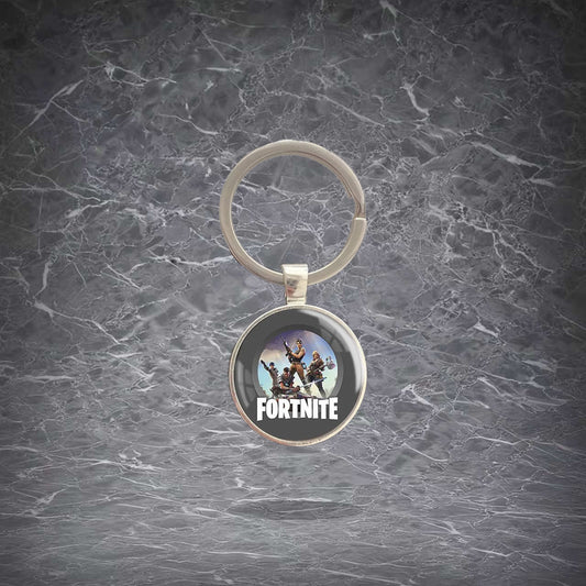 Round Fortnite-themed keychain featuring character artwork and the game logo, set in a shiny metal frame with a sturdy split ring. Lightweight, scratch-resistant pendant for keys, backpacks, and bags. Ideal for fans to show off their love for the game.
