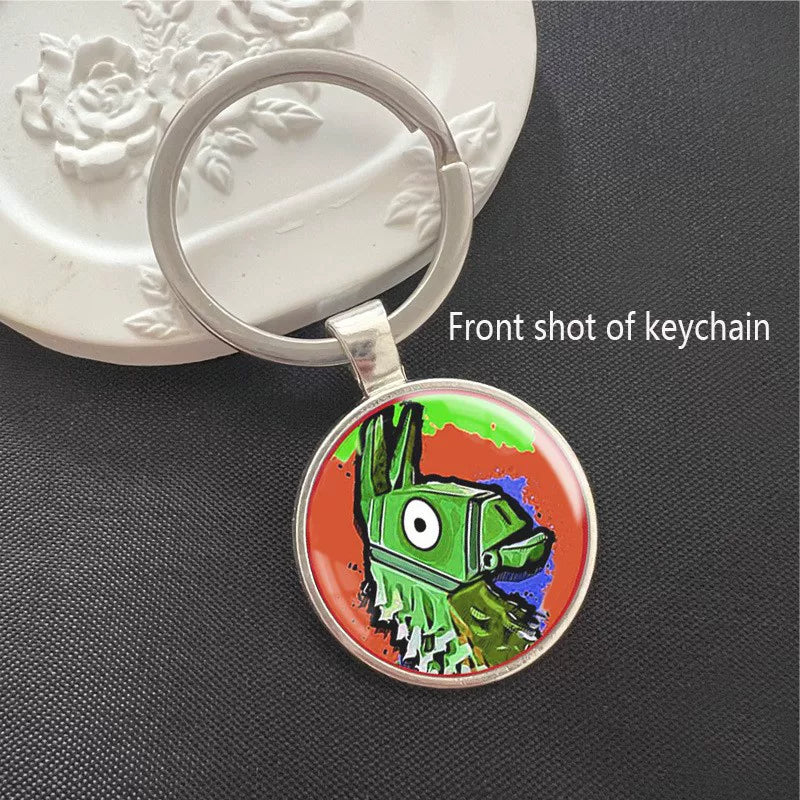 Fortnite-themed keychain featuring a vibrant, colorful loot llama design, encased in a polished silver frame with a scratch-resistant dome. Perfect for keys or backpacks.