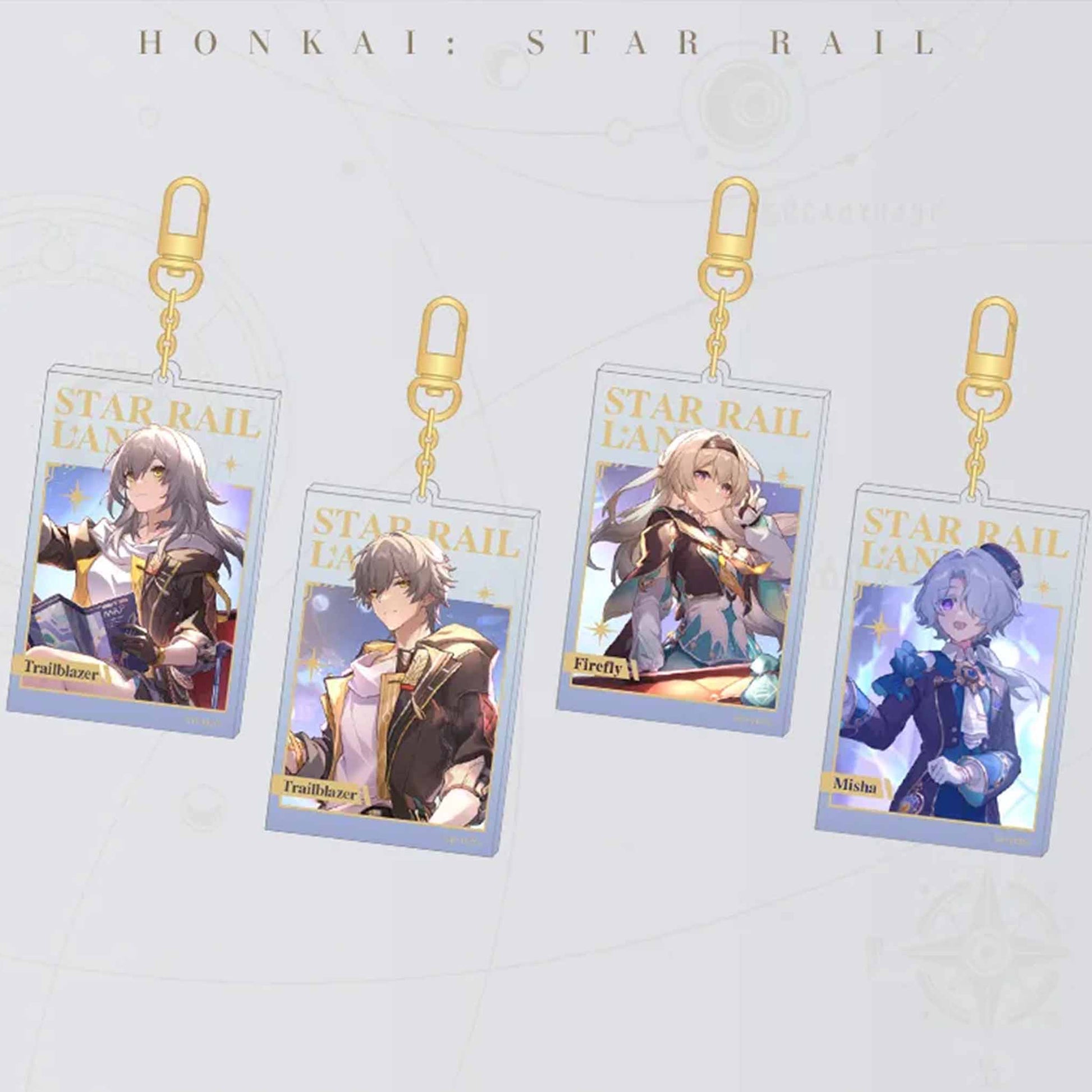 Four Honkai: Star Rail acrylic card keychains are displayed, each with a gold carabiner. They feature characters Trailblazer (Female/Male), Firefly, and Misha, with “STAR RAIL LANE” printed in gold foil.