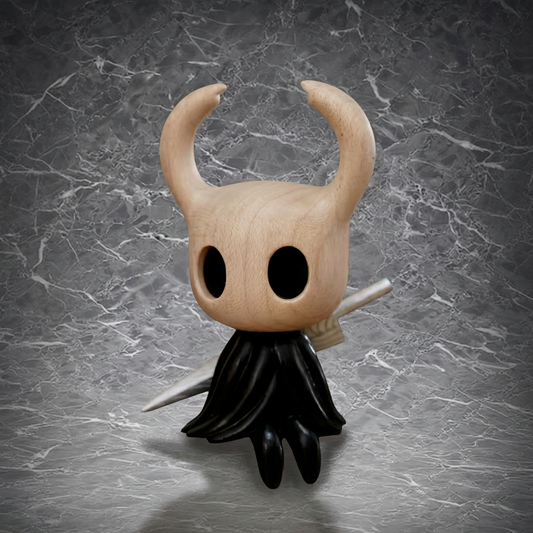 This is a charming figurine of a character with a wooden - like head, large hollow eyes, curved horns, a black flowing cloak, and a silver weapon, perfect for collectors and fans of unique art styles.