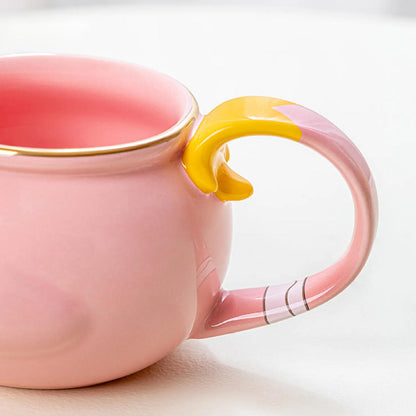 A close-up of the mug’s handle shows its two-tone pink-and-yellow design with subtle painted stripes, highlighting the handcrafted details of this Genshin Impact collectible.