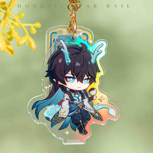 A single Honkai: Star Rail laser-acrylic keychain stand with a gold clasp. The charm shows the black-haired, horned chibi character Dan Heng • Imbibitor Lunae, on a teal branded base with a holographic edge.