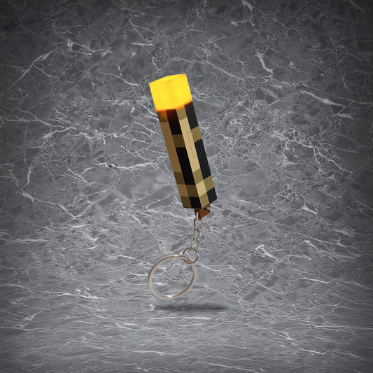 Pixel art torch keychain with LED light, available in USB rechargeable or battery powered options, glowing yellow.
