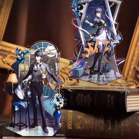 Two Wuthering Waves acrylic stands: a refined male character by a sunlit window and a whimsical female figure framed by butterflies and ribbons, set against antique books.