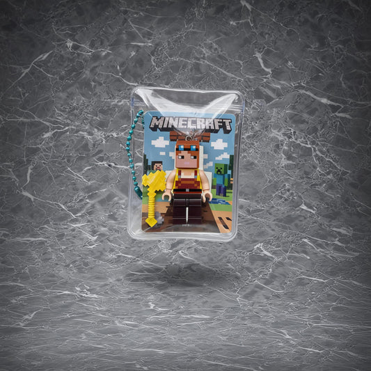 Minecraft Alice Keychain. Pixelated Alice figure in winter-style armor with a blue pickaxe, encased in a clear pouch with a beaded chain.