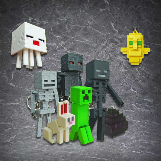 Collection of Minecraft 3D printed keychains featuring iconic mobs including Ghast, Creeper, Skeleton, Wither Skeleton, Enderman, Rabbit, and Bee, displayed against a light brown marble texture background. 