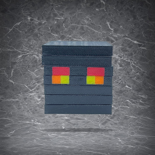 Minecraft Magma Cube desktop decoration, black stacked cube design with red, orange, and yellow pixel-style eyes
