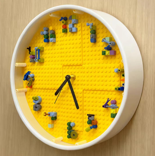Brighten your space with this white-framed clock! Yellow brick baseplate with colorful block details. Perfect for a playful, pixelated vibe in kids' rooms.