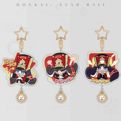 Three Honkai: Star Rail Pom-Pom acrylic keychains are displayed, each with a star-shaped clasp, a clock pendant, and Pom-Pom in a different playful pose.