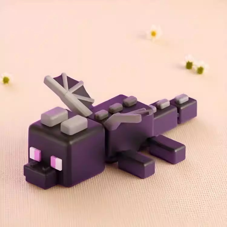 A detailed 3D figurine of the Ender Dragon Hatchling from Minecraft, featuring blocky purple body and wings with distinct pixelated eyes.