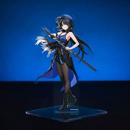 An acrylic stand of the Female Wanderer from Wuthering Waves, capturing her dynamic pose with a polearm, black-and-blue gradient cape, and flowing dark hair against a vivid blue background.