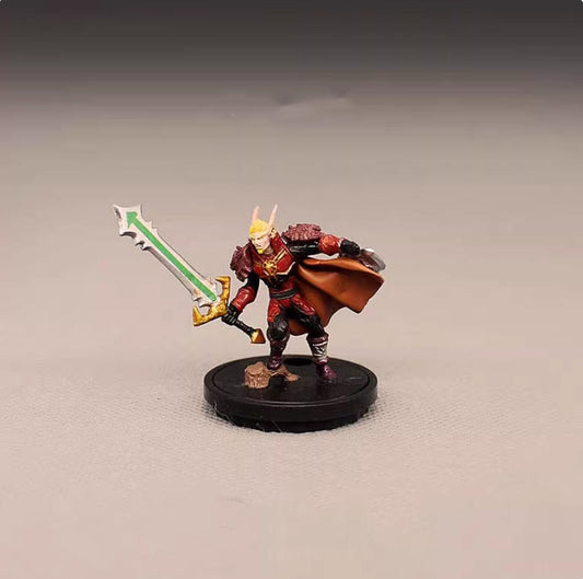 This finely painted plastic miniature features a red elf warrior in detailed armor, wielding a glowing green sword and a flowing cape. Compact and vivid, it’s perfect for tabletop RPGs, display, or collection. Durable build with striking color contrast.