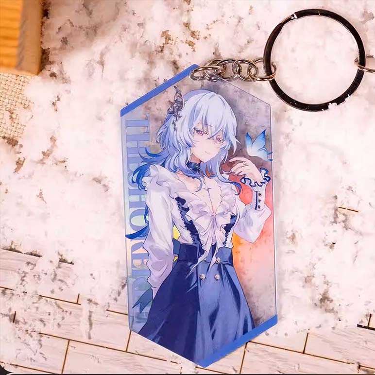 A prism-shaped holographic acrylic keychain of The Shorekeeper, featuring her pale blue hair and elegant outfit, with her name printed vertically on a blue border.